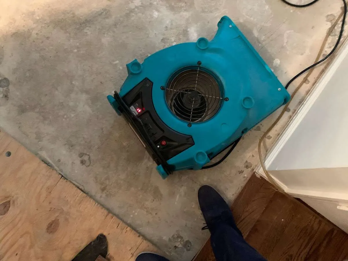 Air mover drying subfloor during Commercial Water Damage Restoration in Osceola